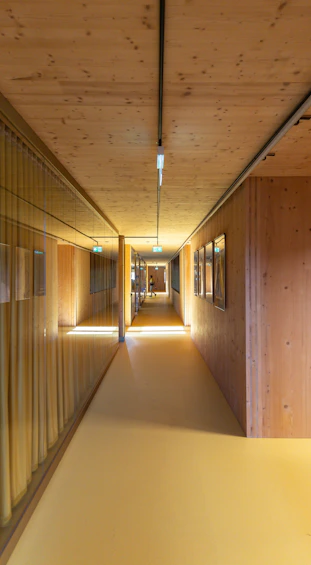 a long hallway with wooden walls and a yellow floor