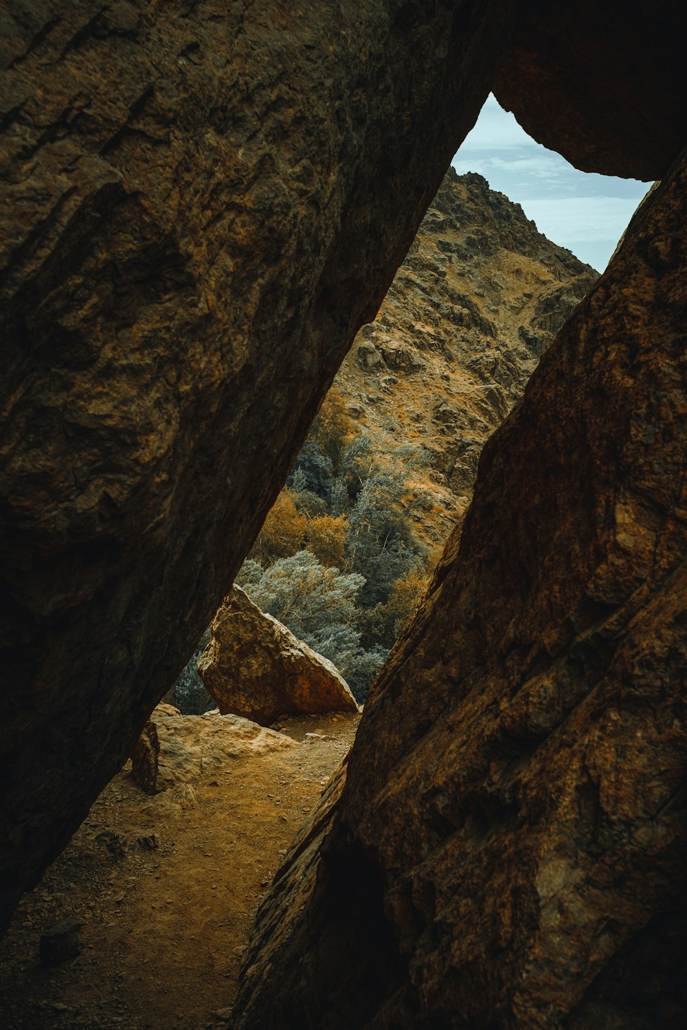 a view of a rocky area through a hole in a rock