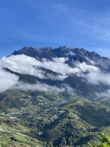 a view of a mountain range with clouds in the sky