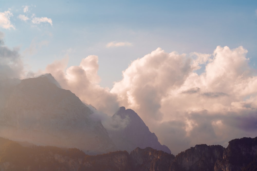 a mountain range with clouds in the sky