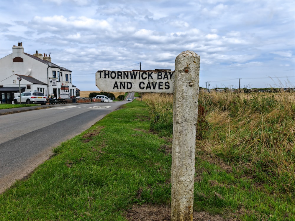 a sign on the side of the road that says thornwick bay and caves