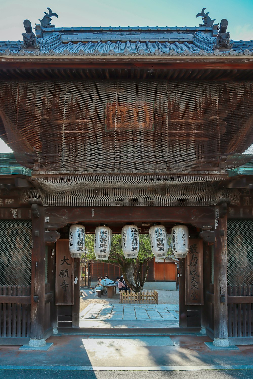 a large wooden building with a blue sky in the background