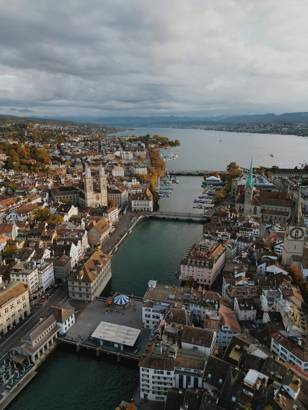 an aerial view of a city next to a body of water