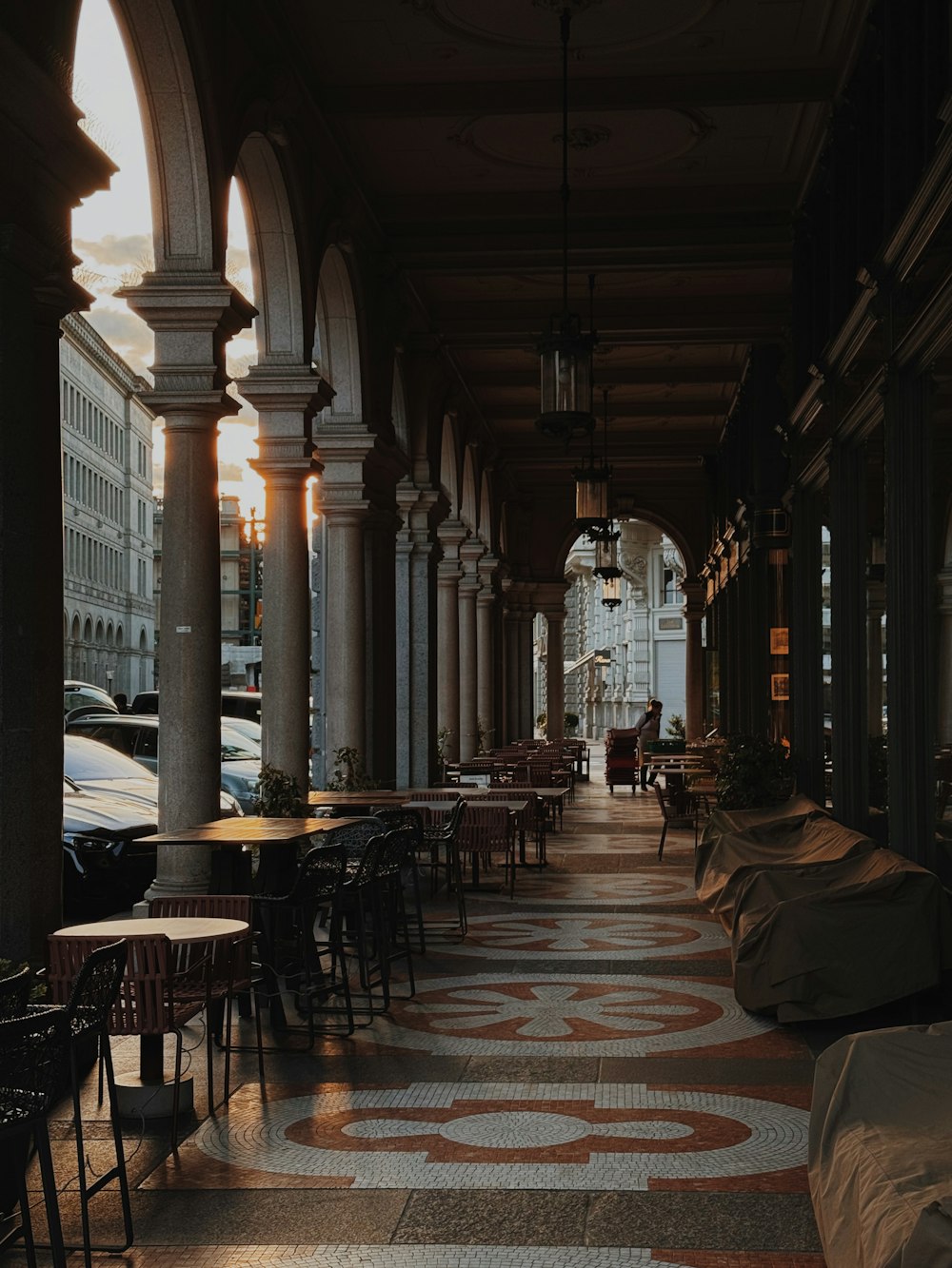 a long hallway with tables and chairs on both sides of it