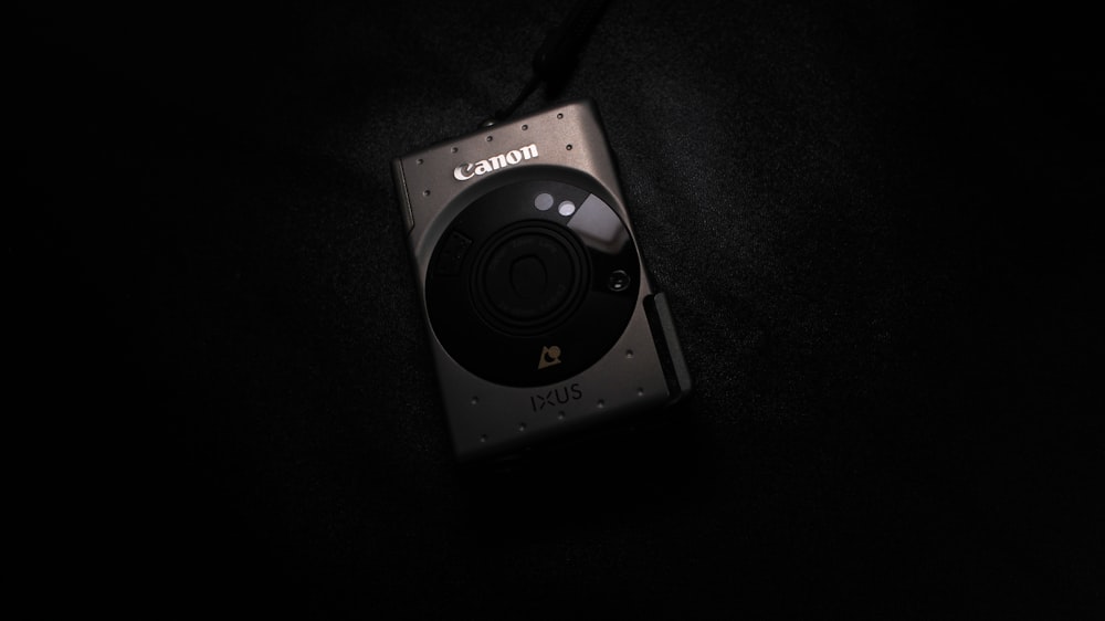 a camera sitting on top of a black surface