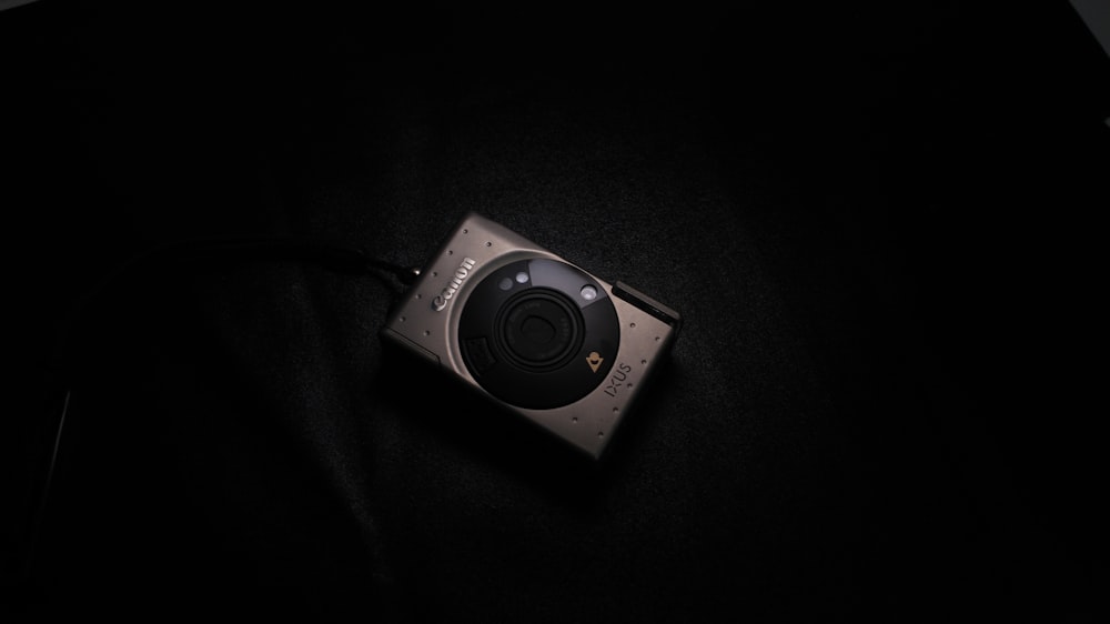 a camera sitting on top of a black surface