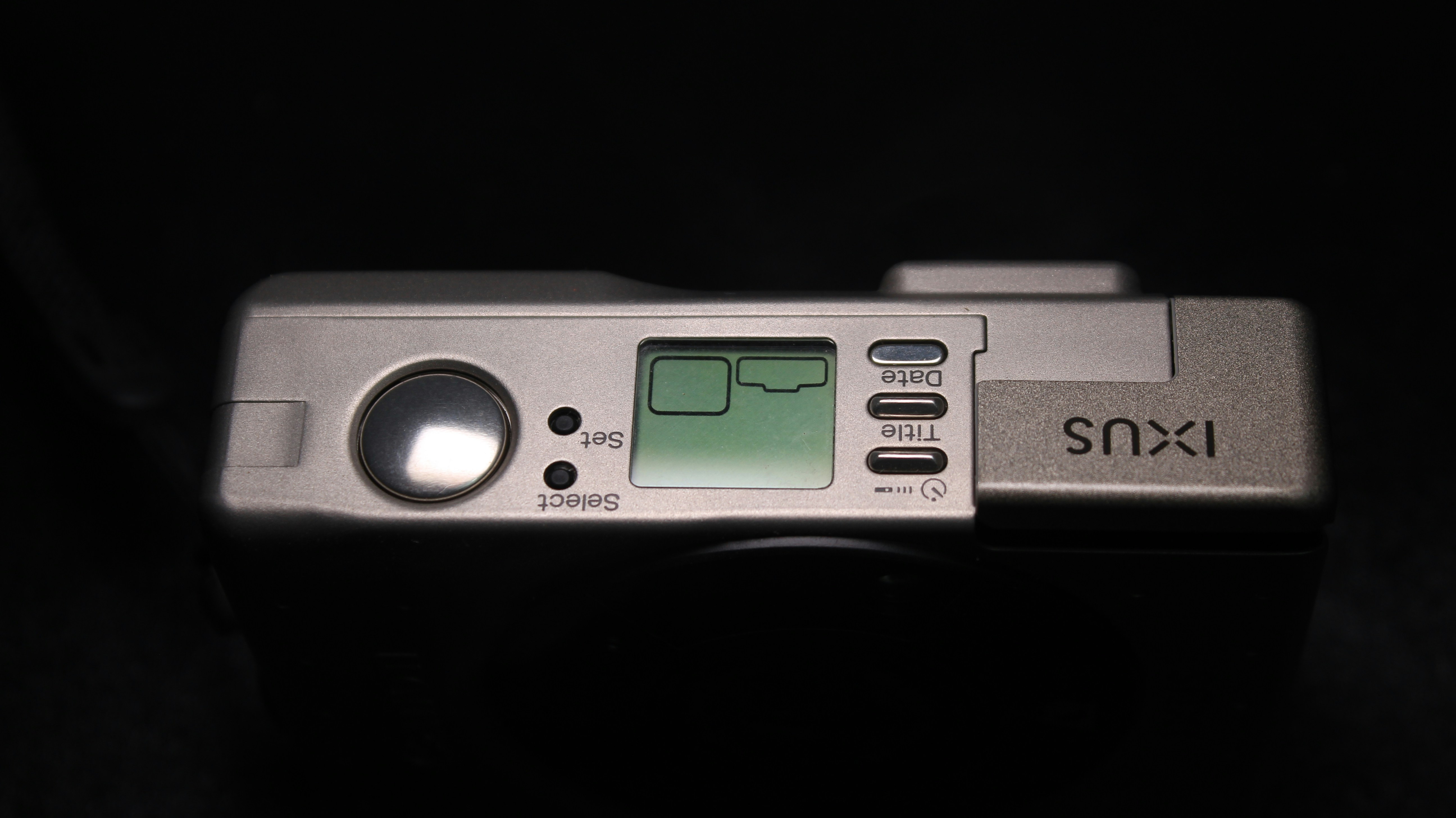 a close up of a digital camera on a black background