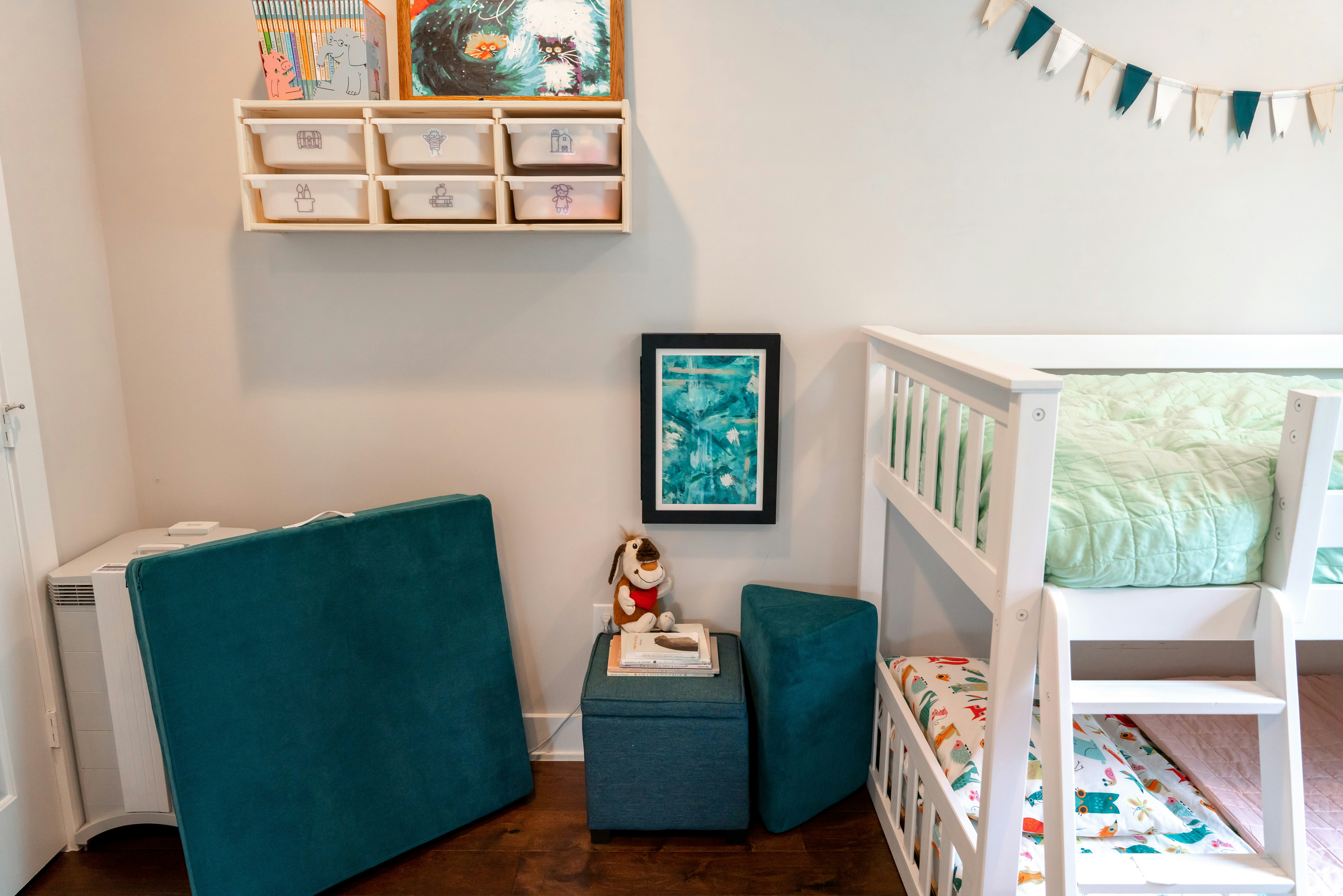Bright kids bedroom with white twin bunk bed and colorful bedding
