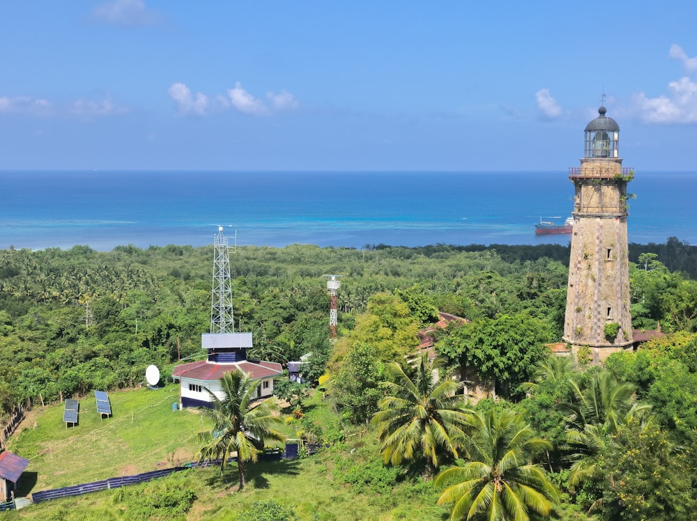 an aerial view of a lighthouse surrounded by trees