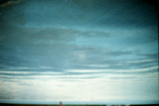 An abstract view resembling a sky with clouds, possibly a reflection or artistic effect. The image gives a sense of vastness and tranquility.