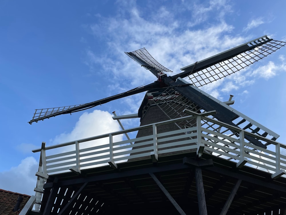a large windmill sitting on top of a wooden structure