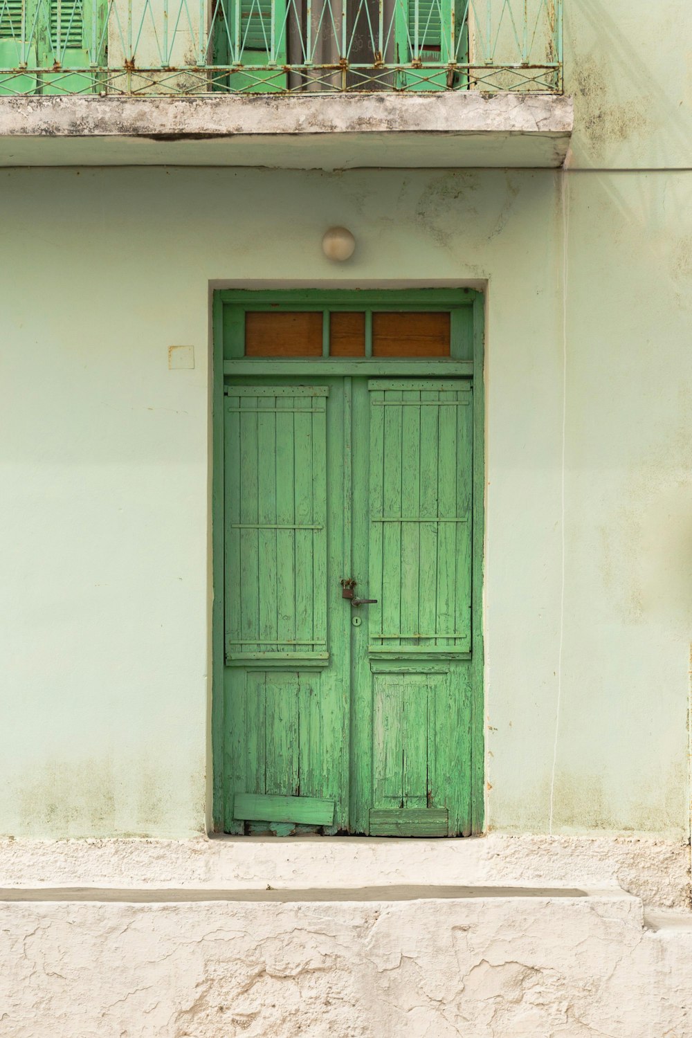 a green door is open on a building