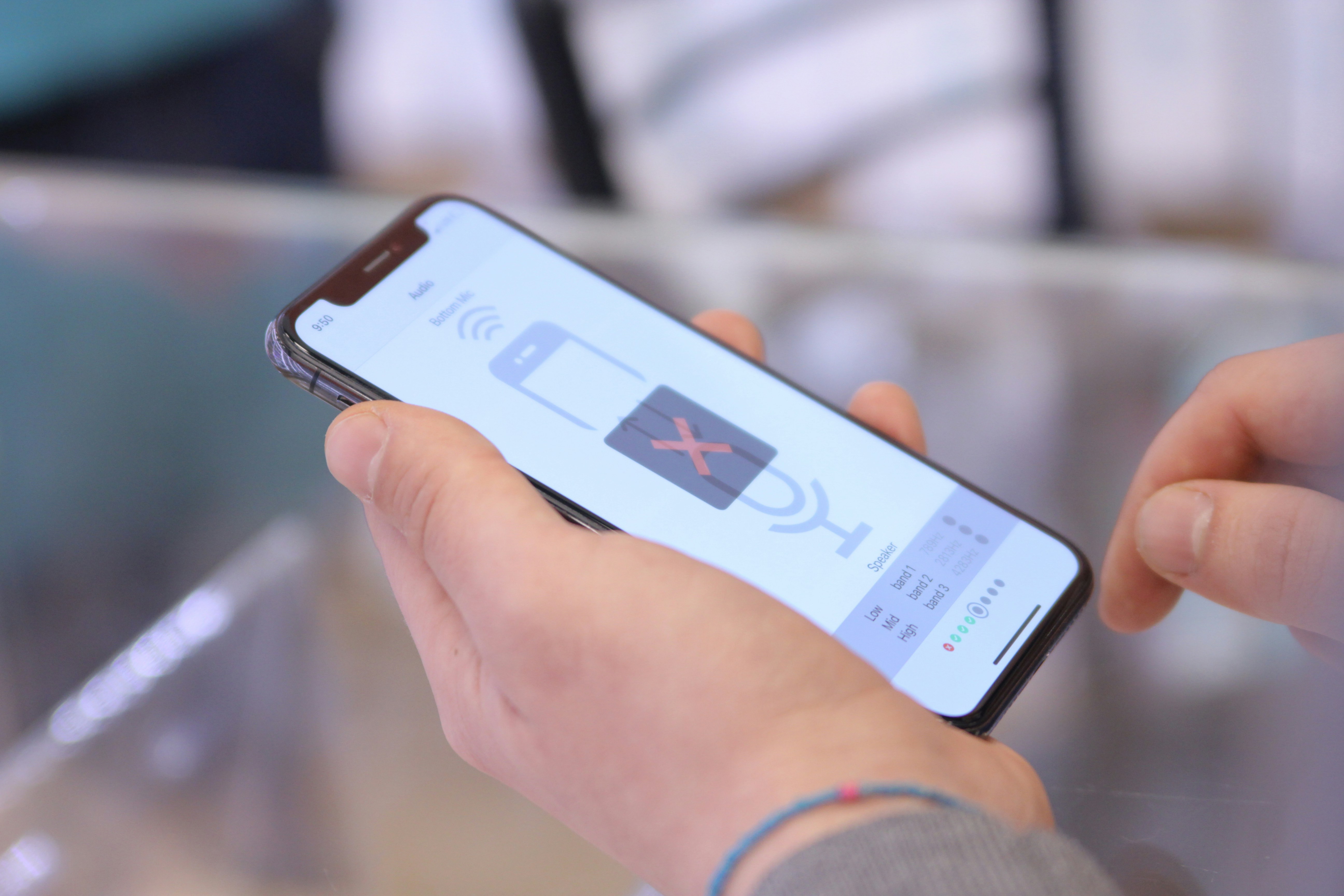 a person holding a cell phone in their hand