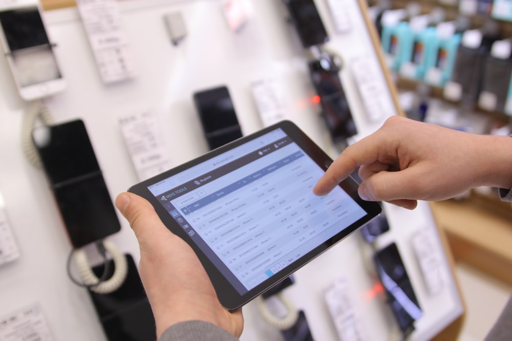 a person holding a tablet in a store