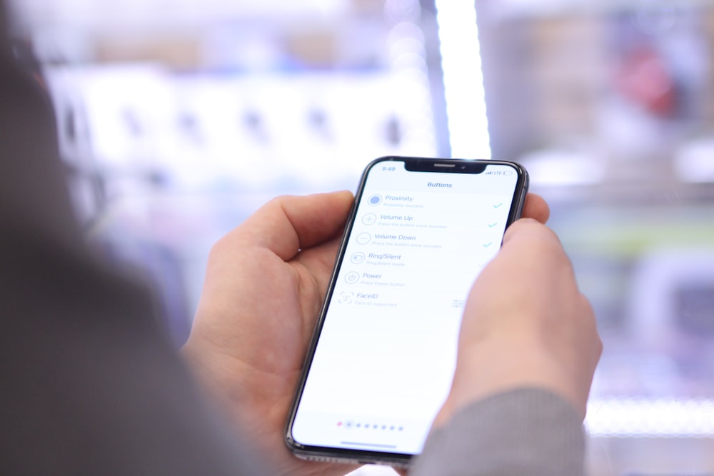 a person holding a cell phone in their hand