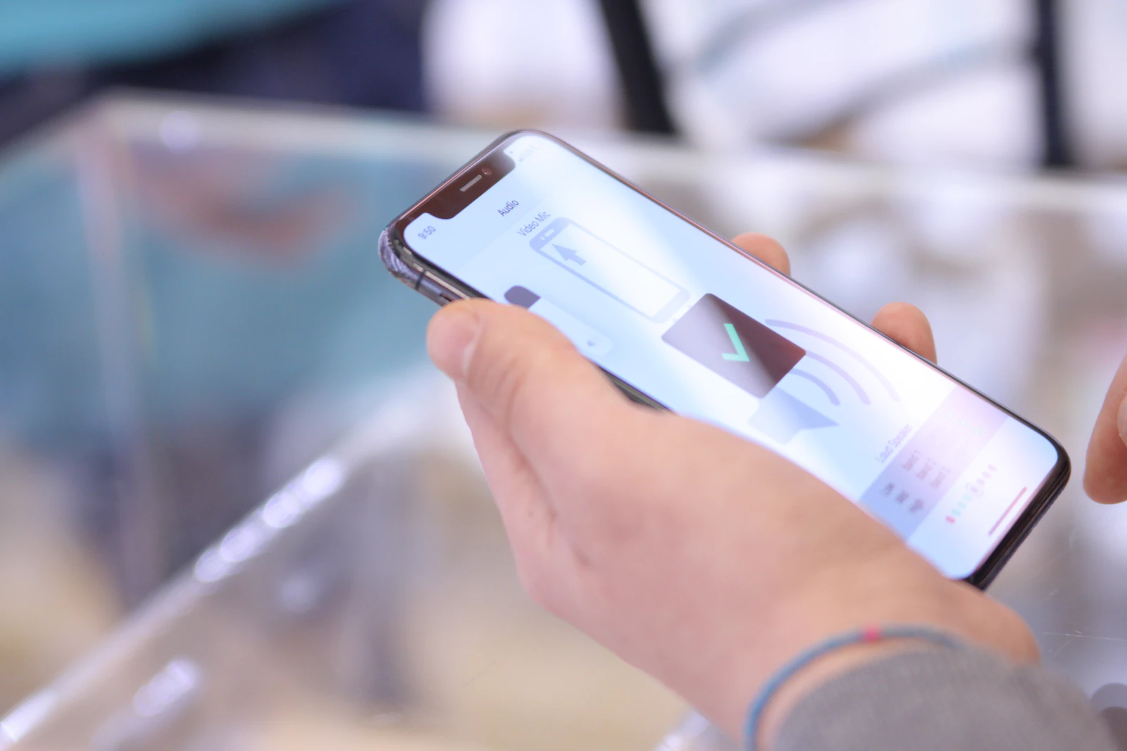 A close-up of a hand holding a smartphone with an app open on screen
