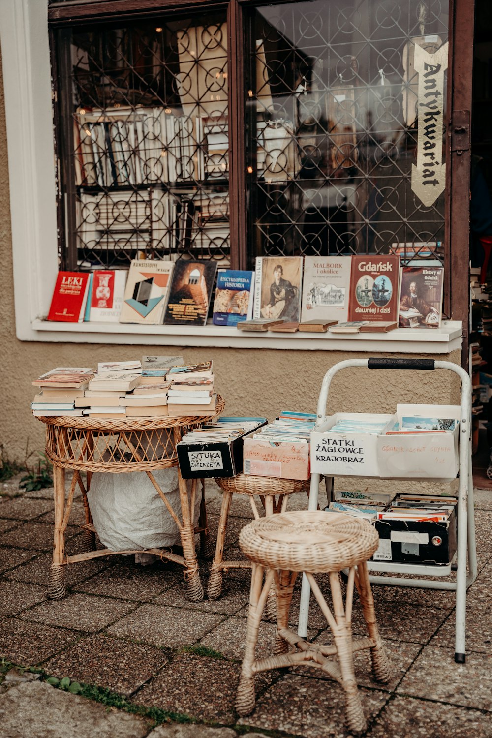 a couple of tables and chairs outside of a store