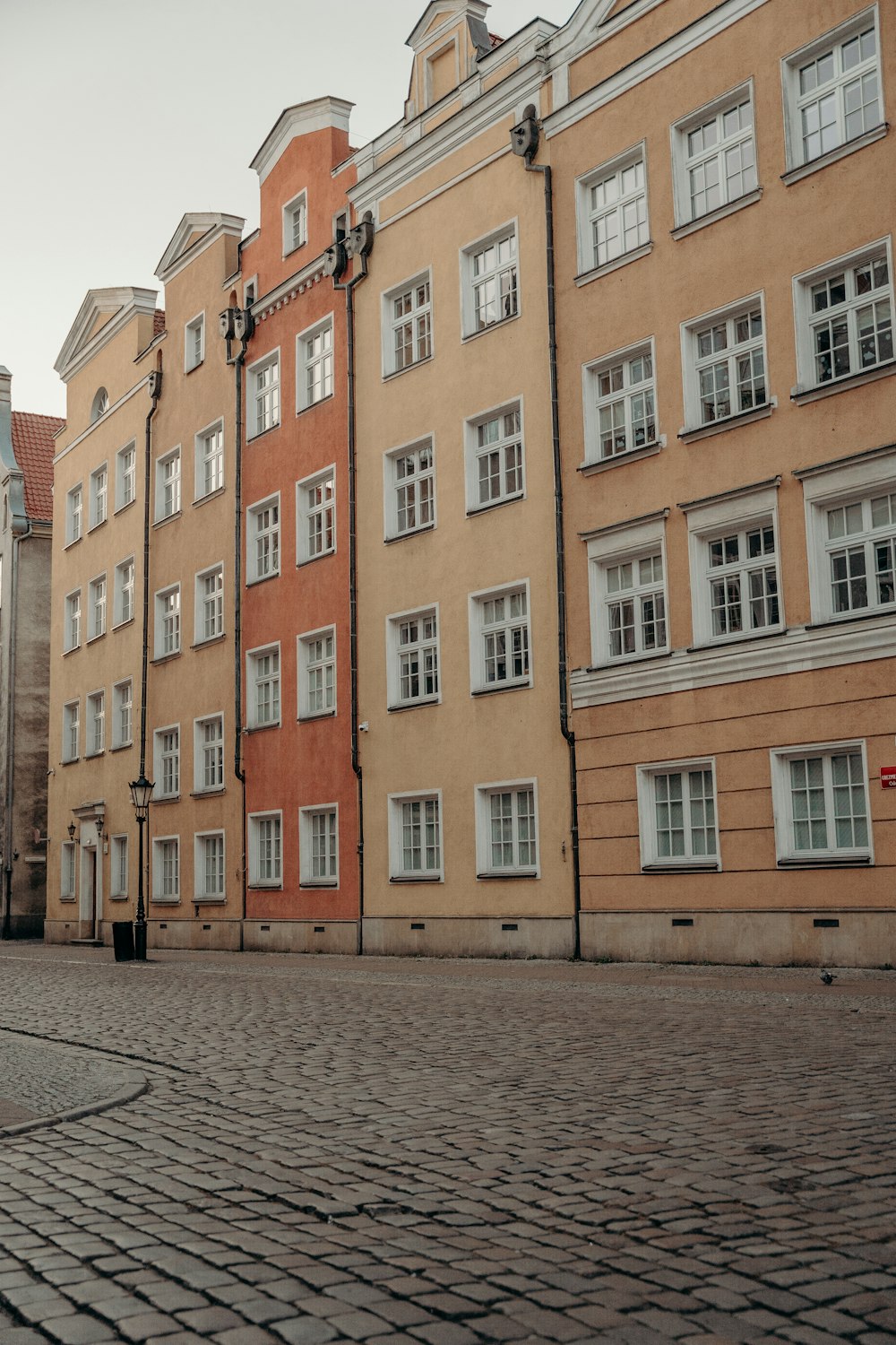 a brick street with a clock tower in the background