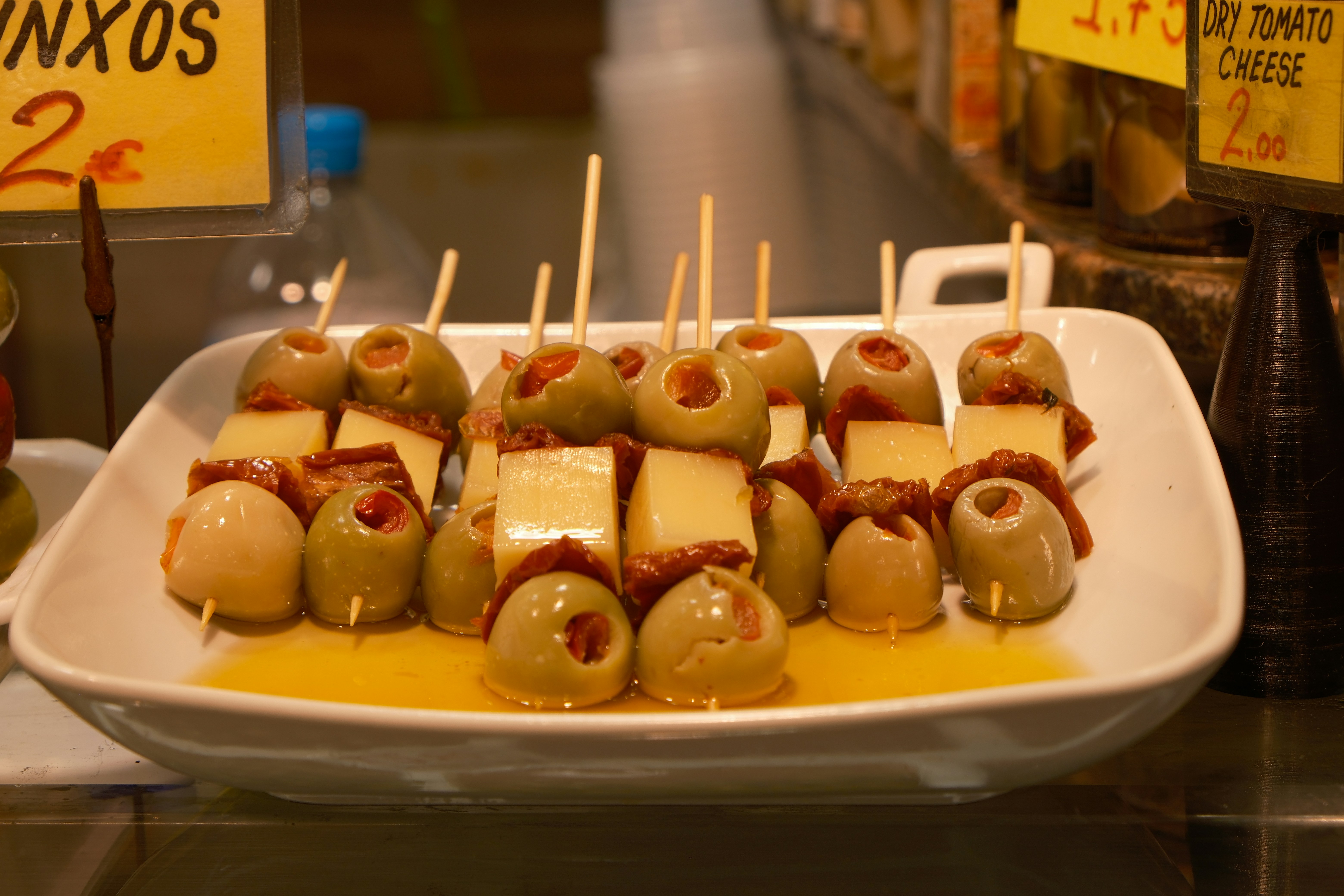 a white plate topped with lots of food covered in cheese