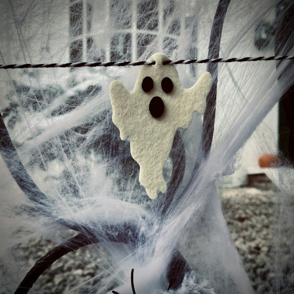 a spooky ghost hanging on a wire fence