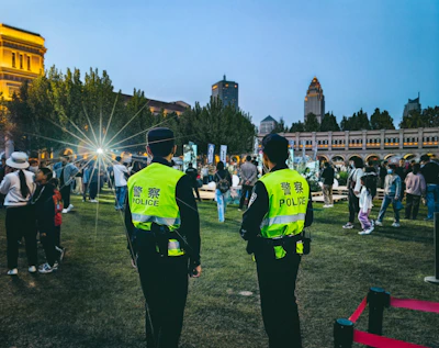 Allsafe Security team coordinating a large event's perimeter safety at dusk.
