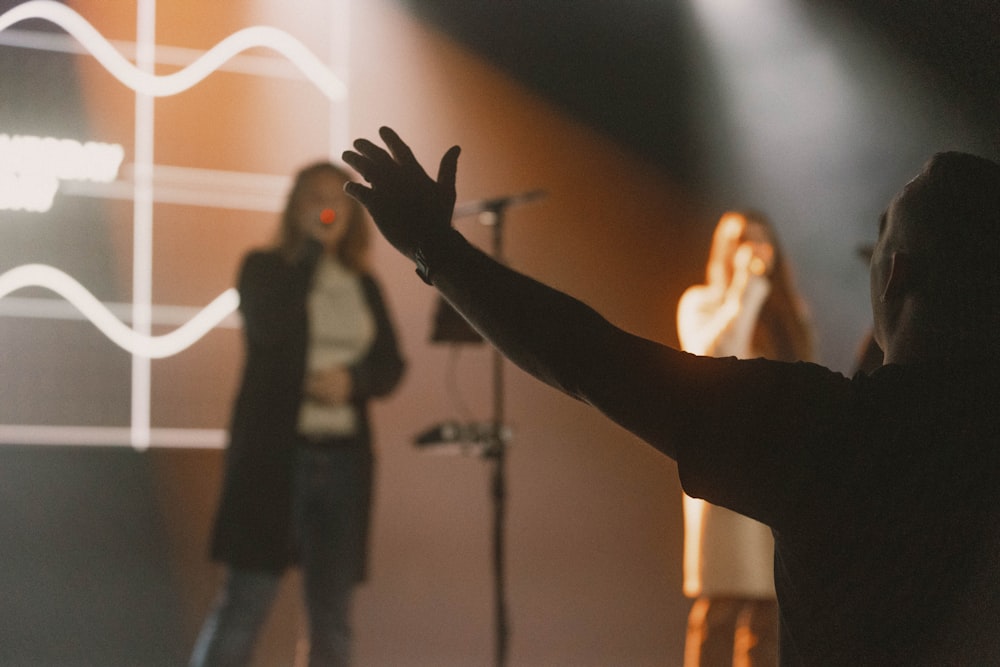 a man standing in front of a microphone on a stage