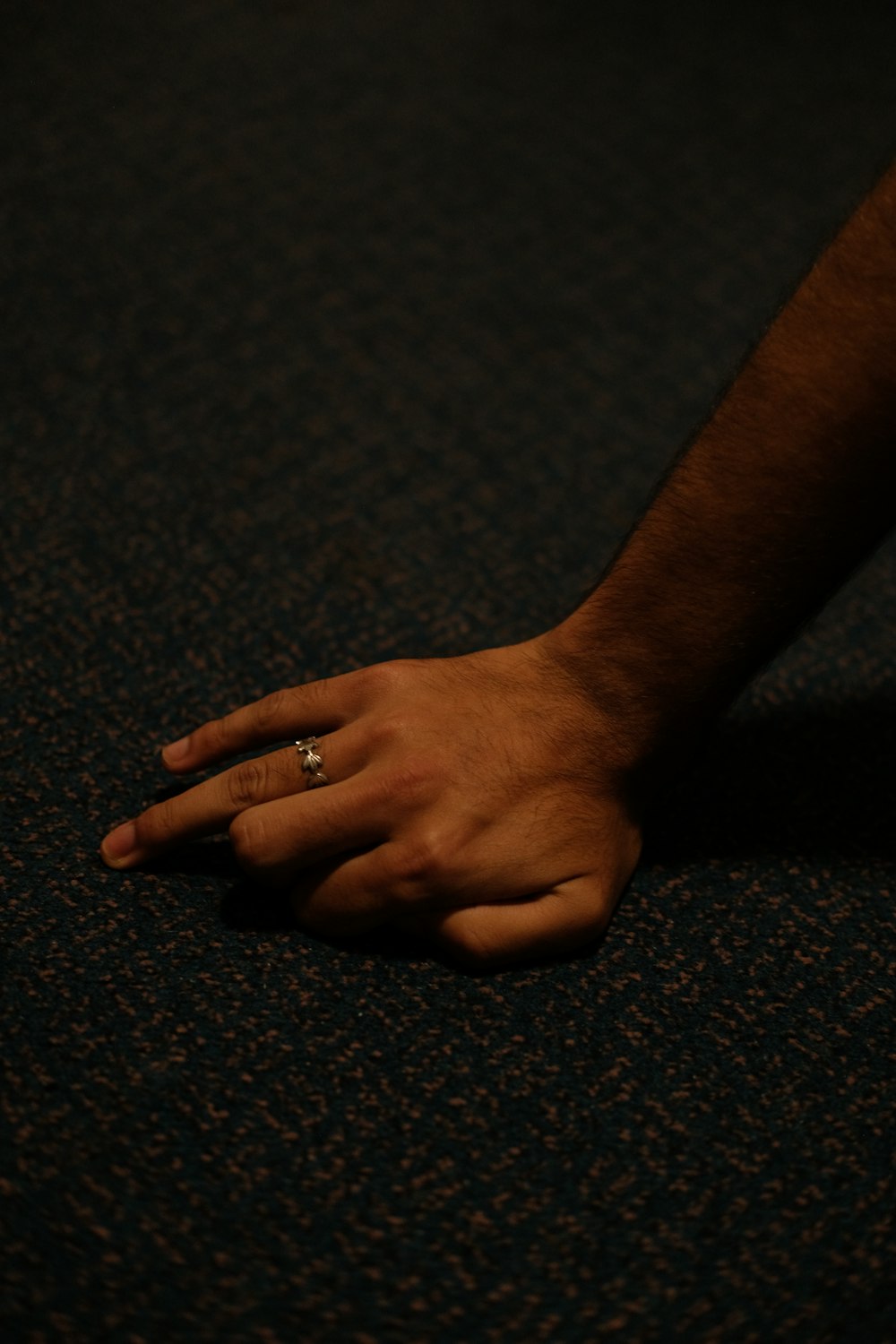 a man's hand with a ring on it