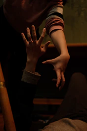 A person reaching out to a supportive friend during a difficult moment.