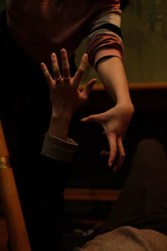 A person reaching out to a supportive friend during a difficult moment.