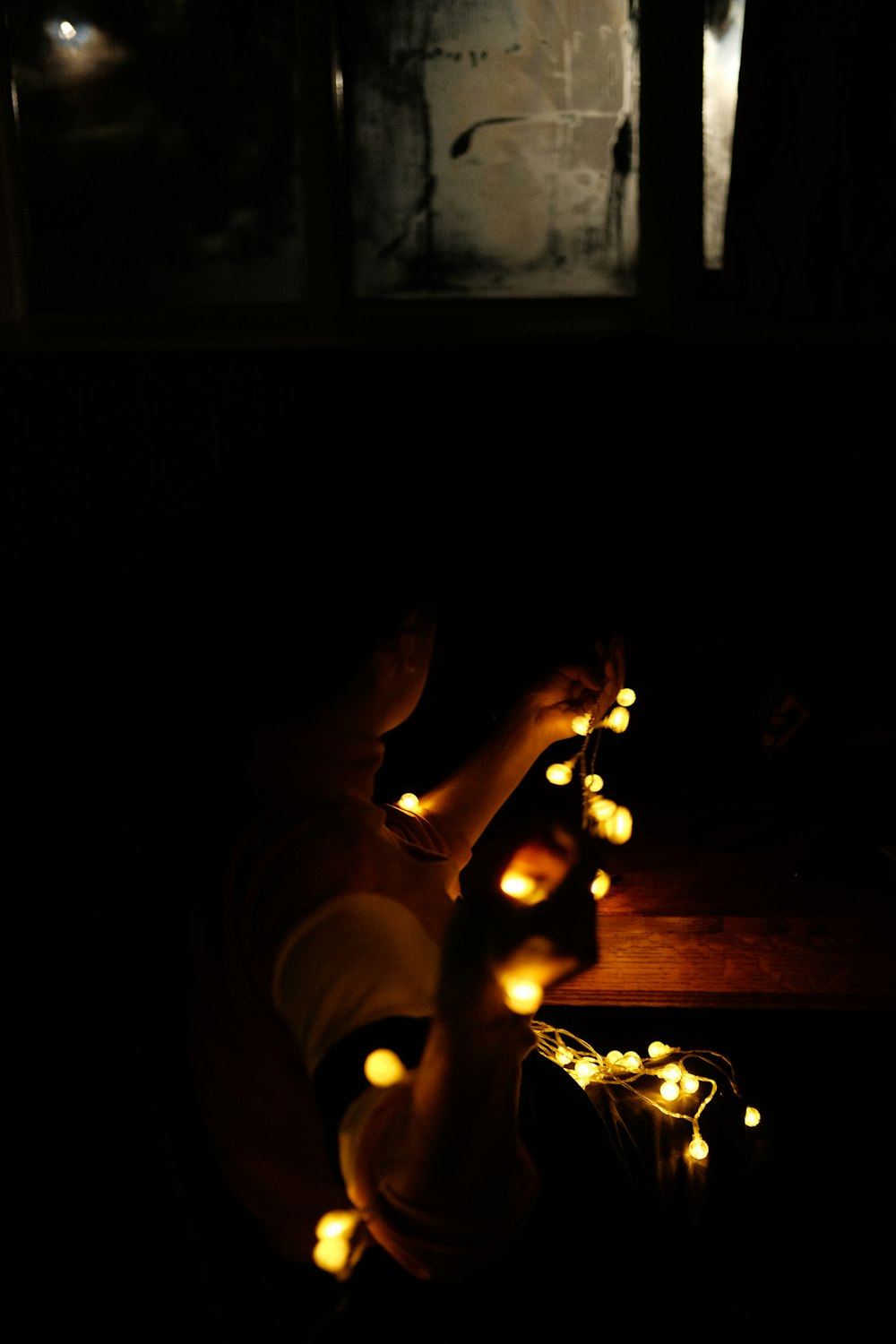 a person sitting down with some lights on their feet