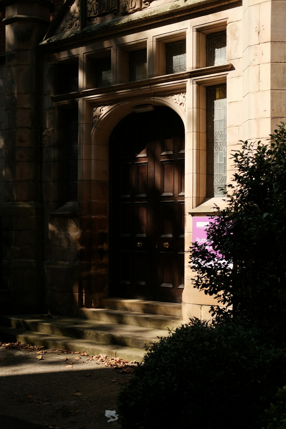 a building with a large door and a clock on the side of it