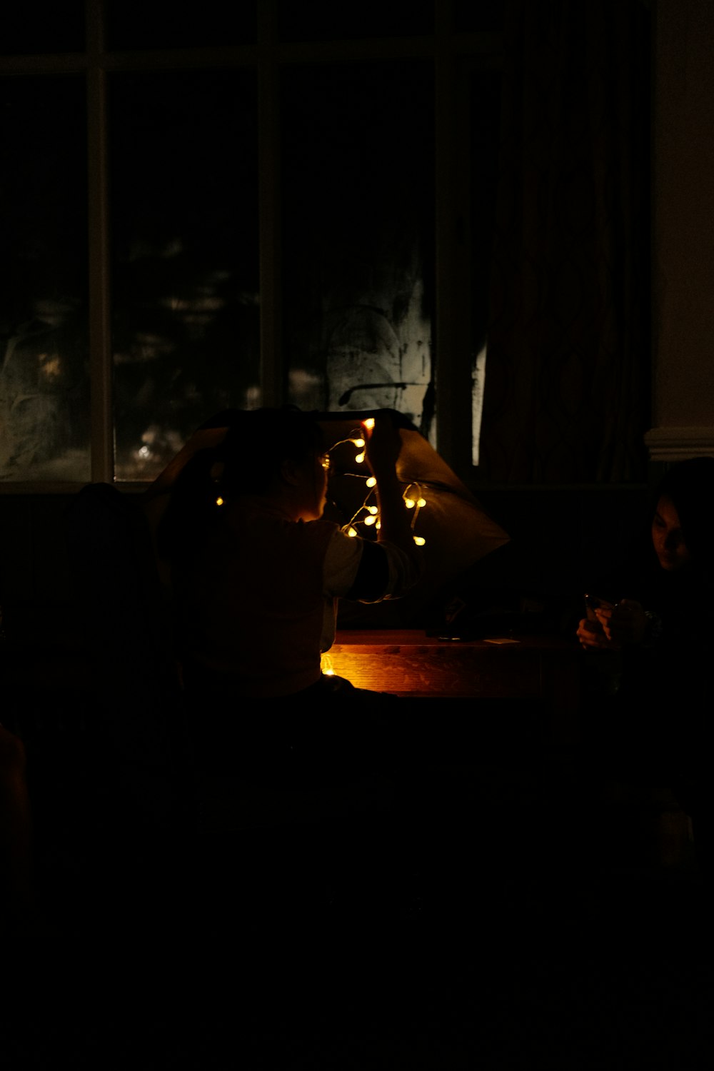 a person sitting on a couch in a dark room
