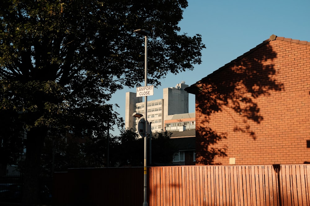 a street sign on a pole next to a brick building