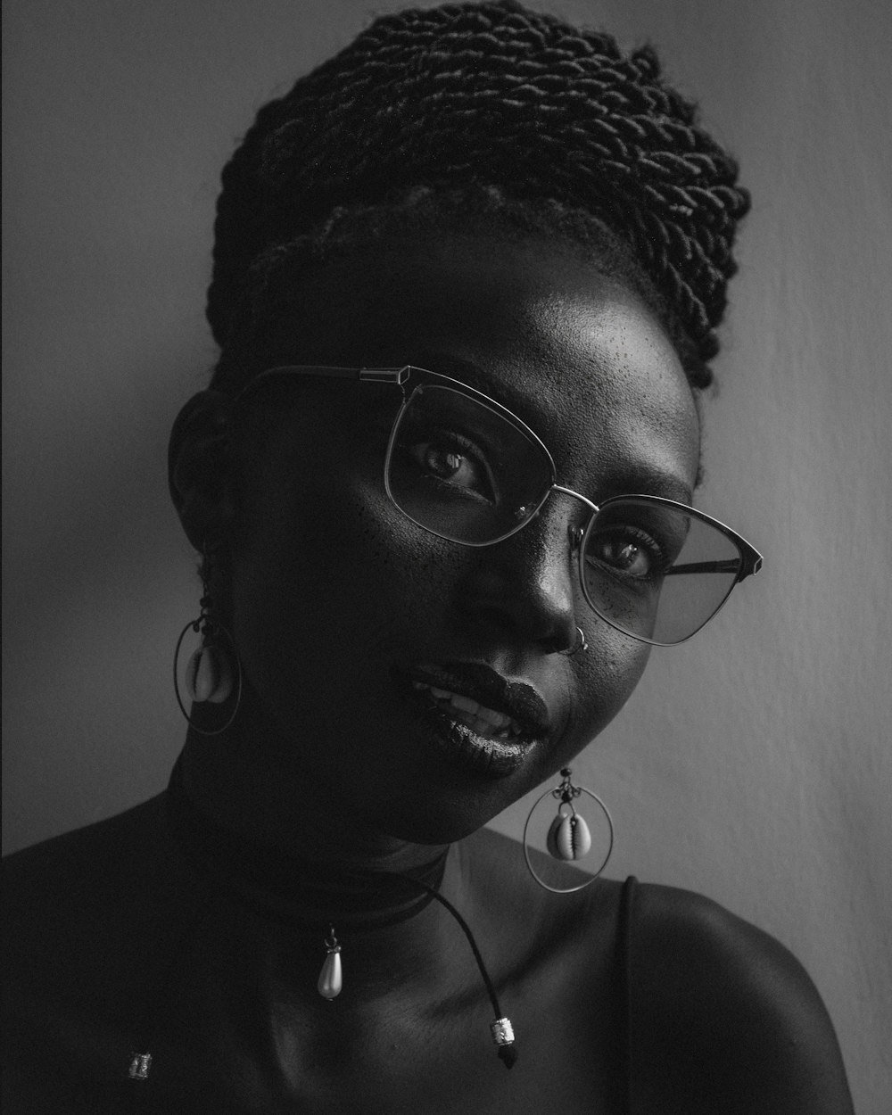 a woman wearing glasses and a necklace