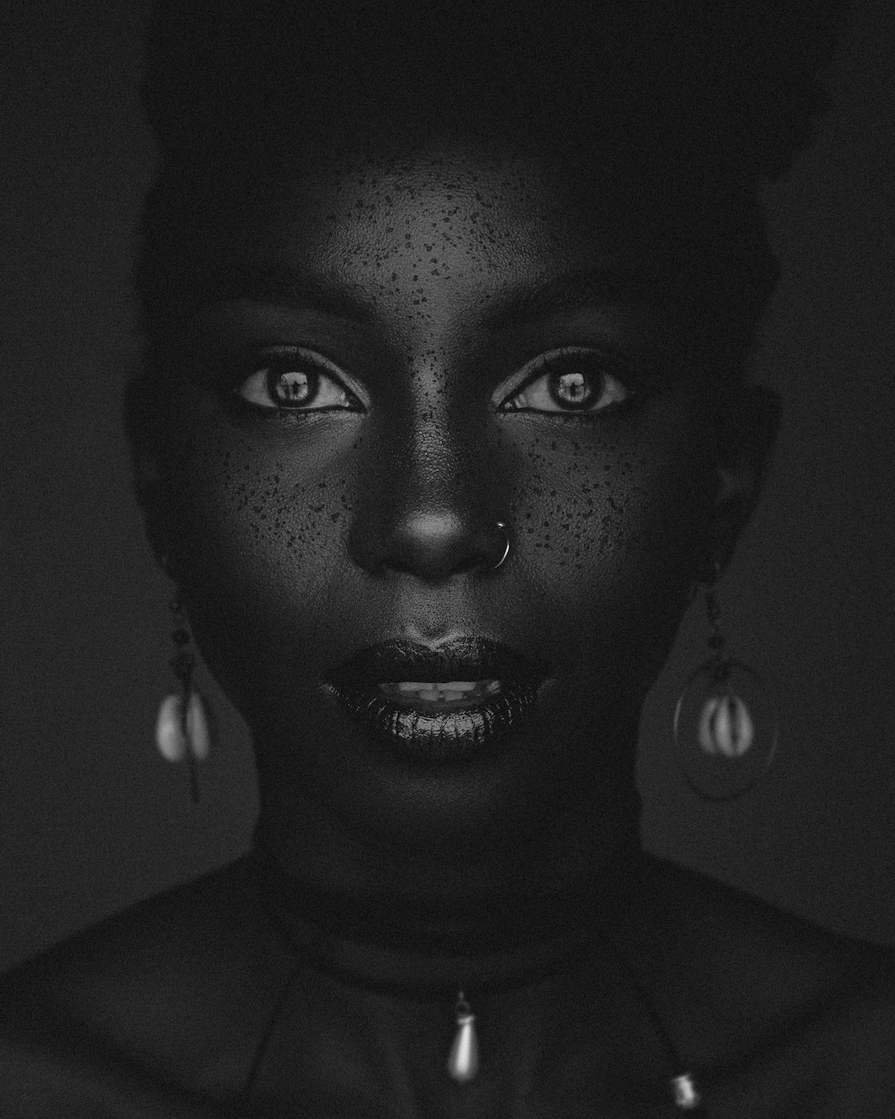 a black woman with freckles on her face