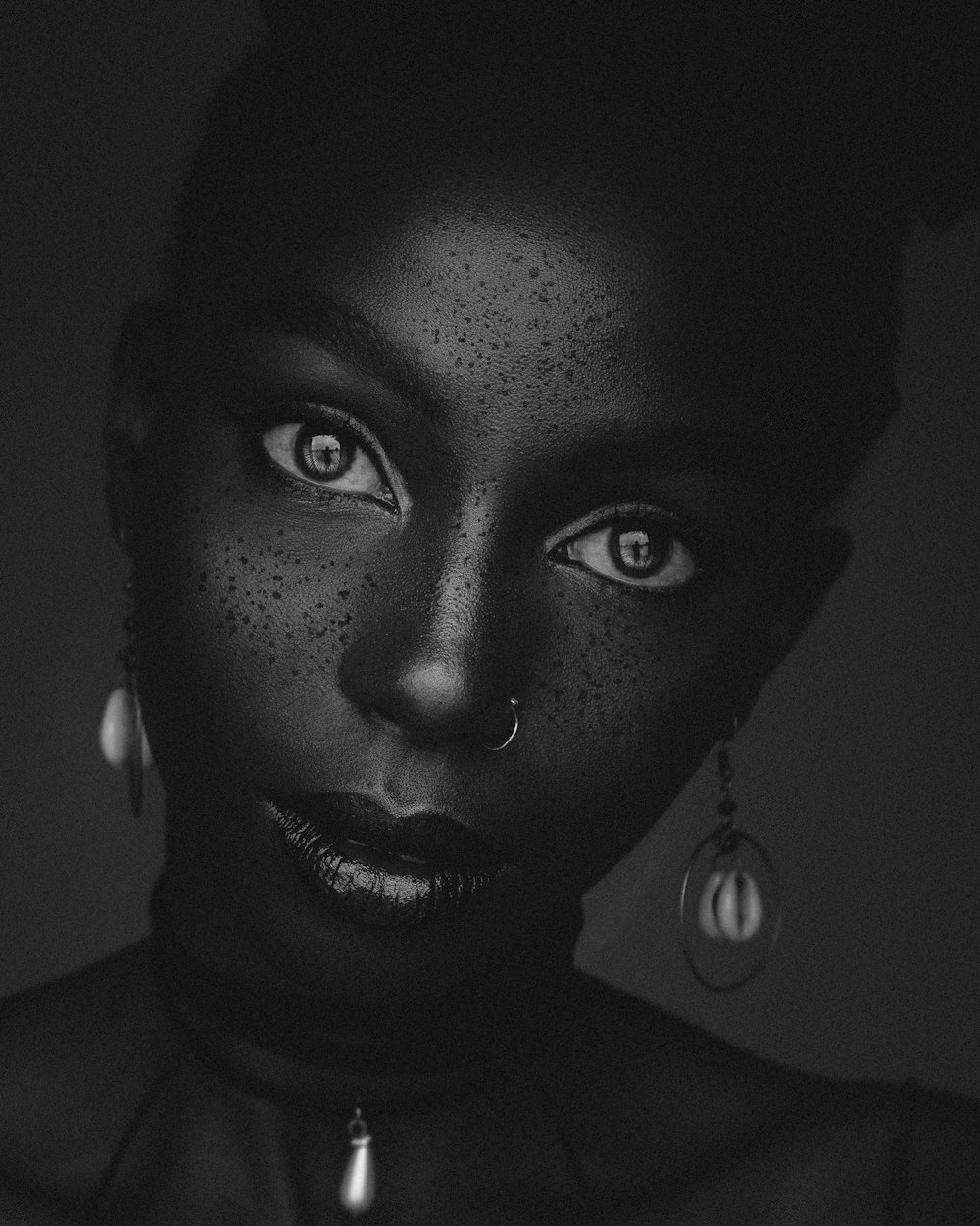 a black woman with freckles on her face