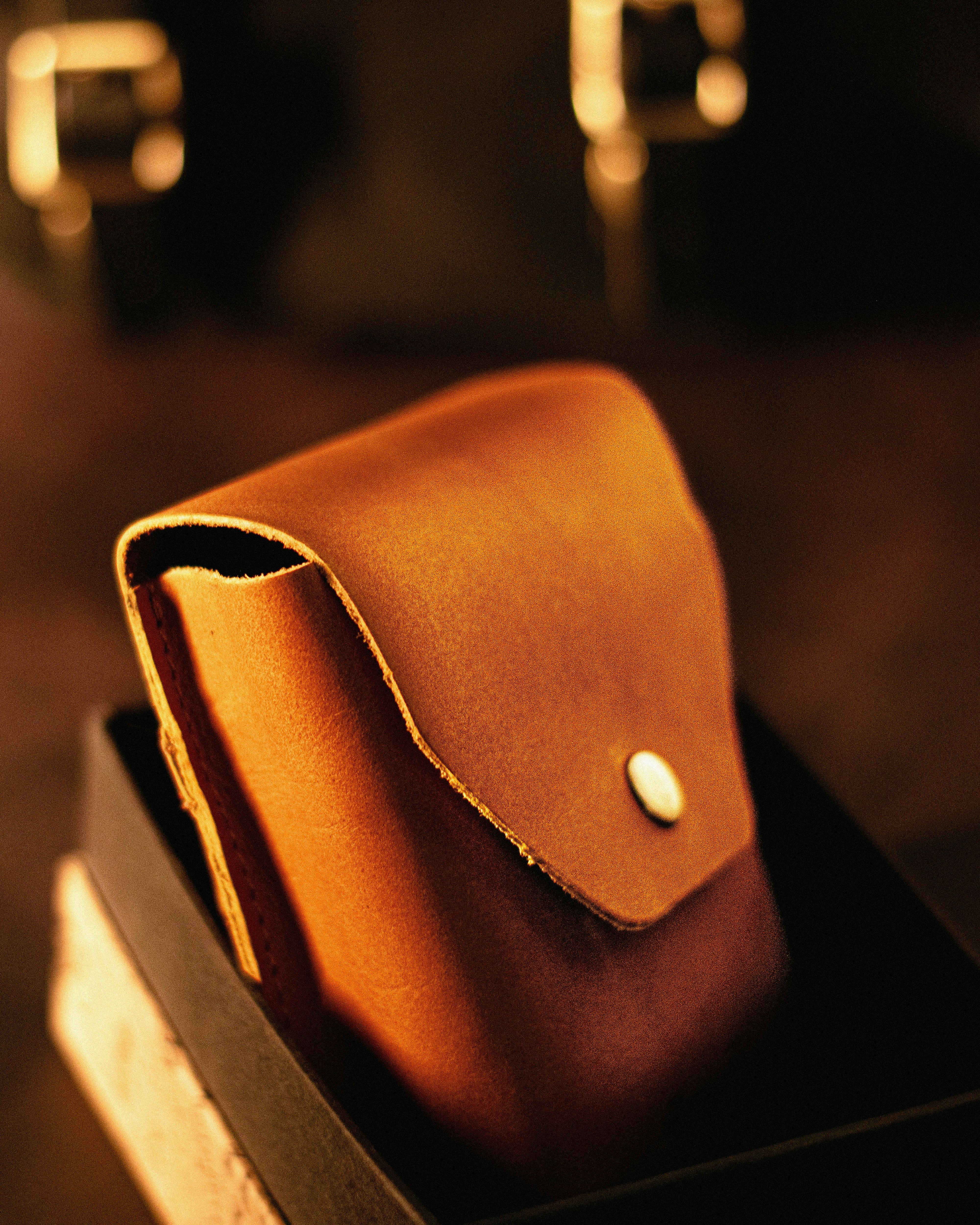 a brown leather pouch sitting on top of a table