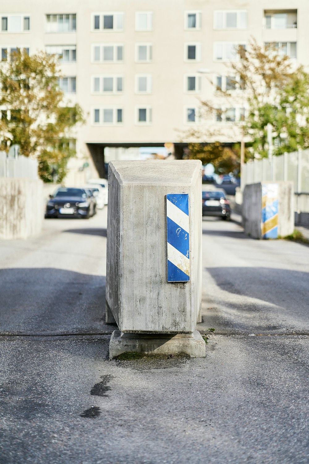 a blue and white box sitting on the side of a road