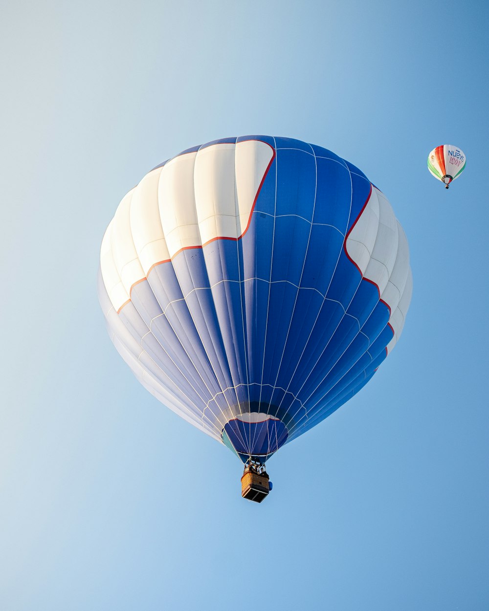 a blue and white hot air balloon and a red and white hot air balloon