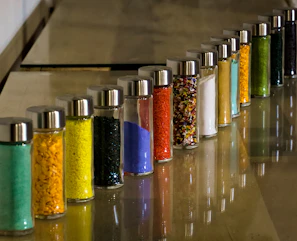 Close-up of colorful chemical powders neatly arranged in laboratory containers