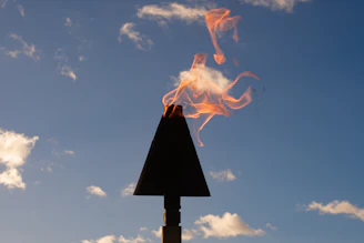 Three icons aligned horizontally: a flickering flame, a sturdy shield, and a broken chain symbolizing freedom.