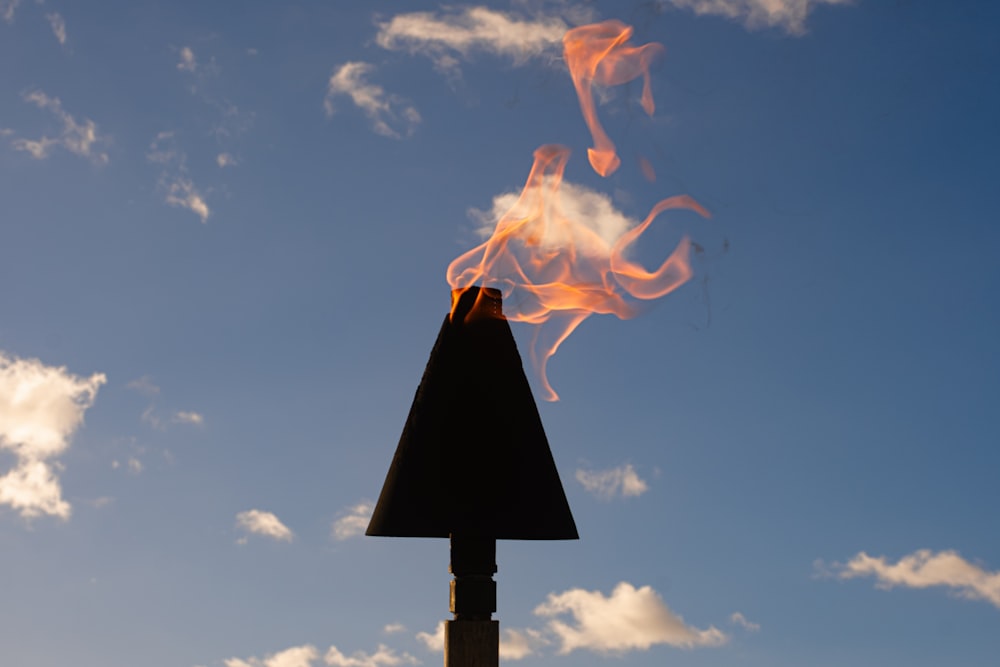 a fire that is on top of a pole