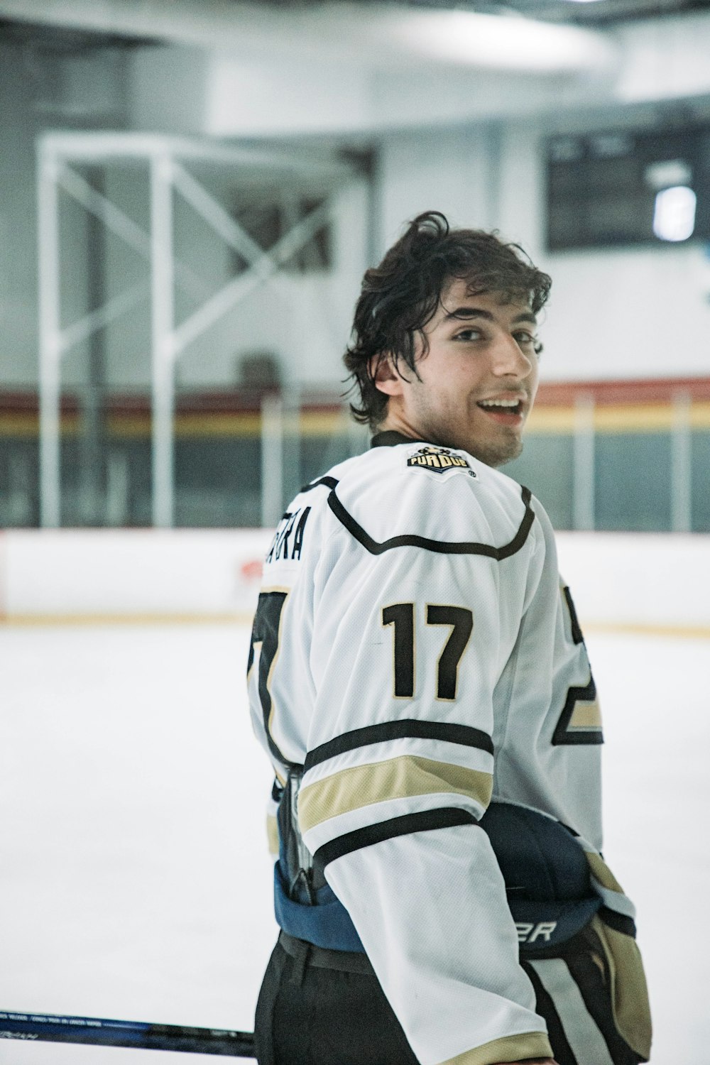 a man in a hockey uniform standing on the ice