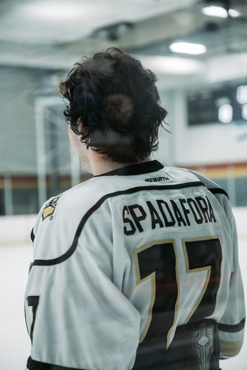 a hockey player is looking out the window