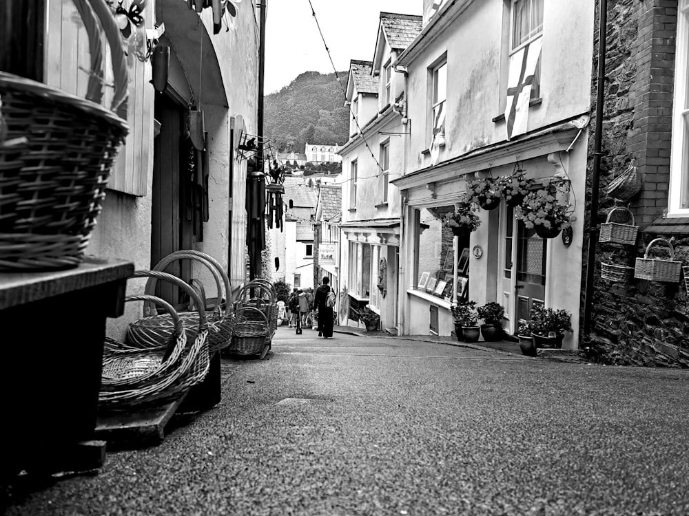 a black and white photo of a narrow street