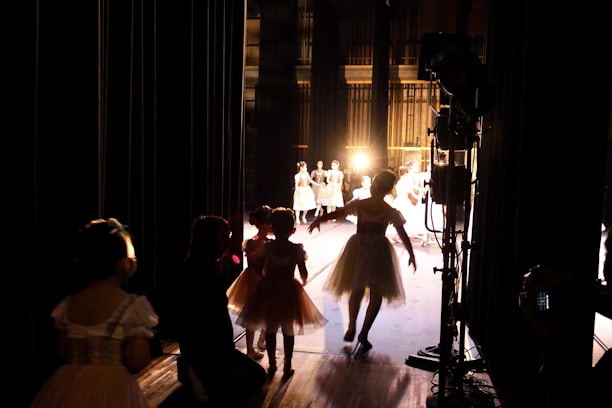A group of diverse performers and crew members collaborating backstage.
