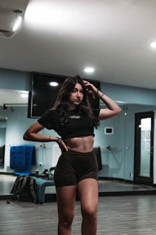 A confident mother practicing Krav Maga moves in a bright, welcoming studio.