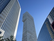 a very tall building towering over other tall buildings