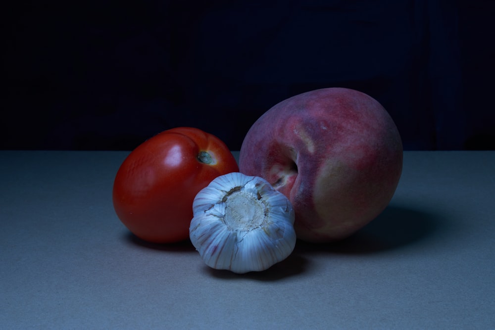 a tomato and an onion on a table