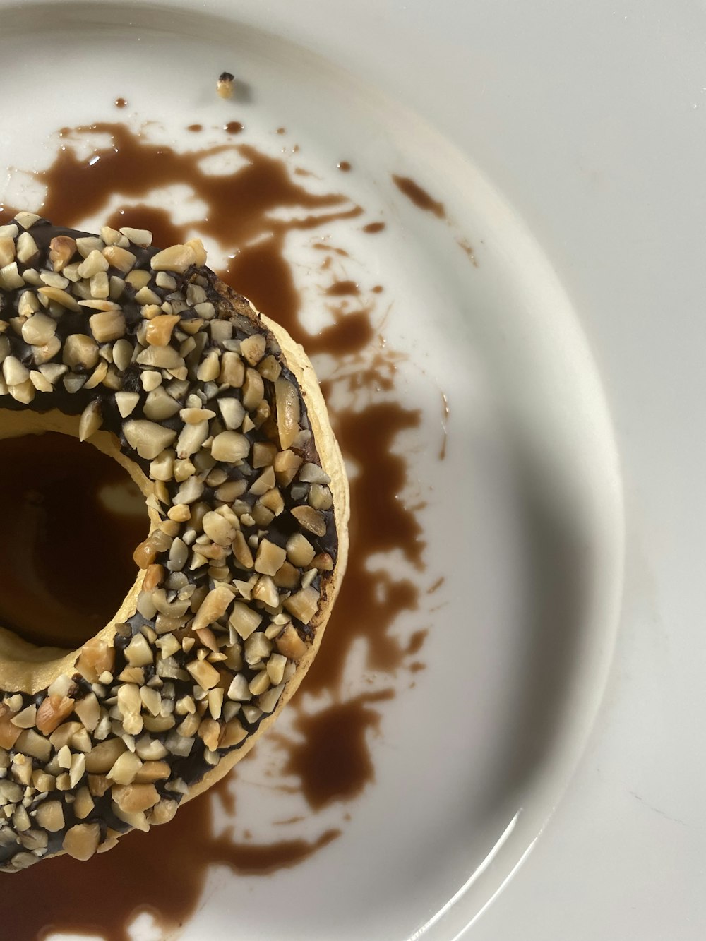 a donut covered in chocolate and sprinkles on a plate